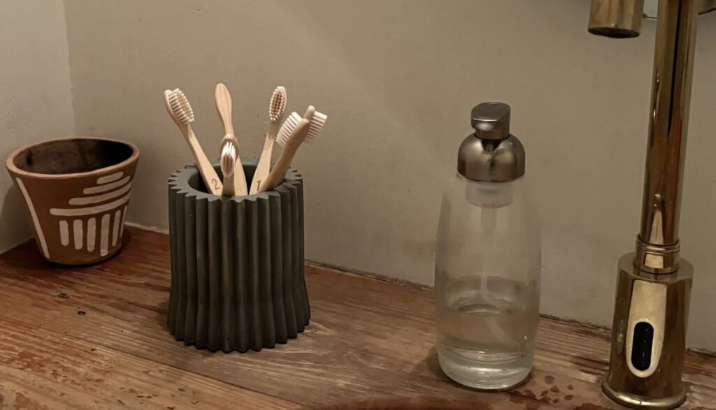 Concrete Toothbrush Holder beside a bathroom sink